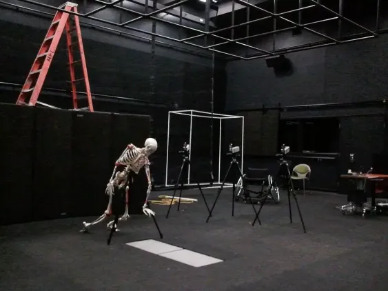 Kennesaw State University - a skeleton hangs in a open room with cameras arranged for a photo shoot.