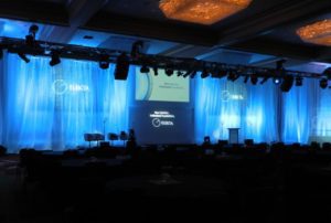 Blue curtains and lighting hightlight stage presentation from Atlanta Pro AV