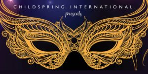 A gold masquerade mask on a purple background for childspring international