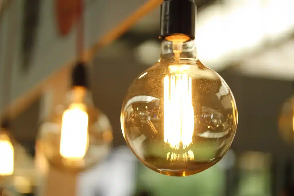 incandescent lightbulbs hand from a ceiling creating a yellow glow.