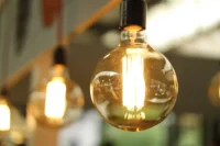 incandescent lightbulbs hand from a ceiling creating a yellow glow.